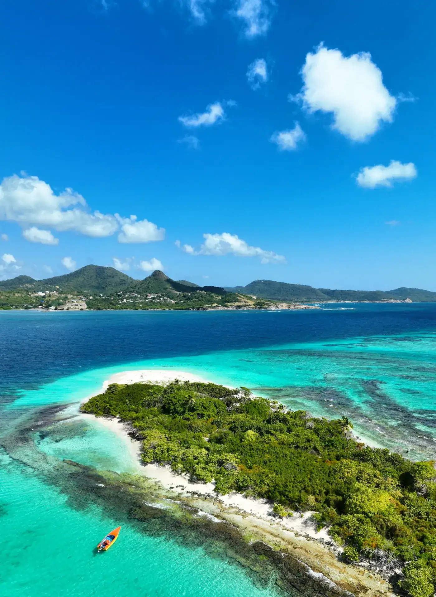 A low sandy cay ringed by crystal clear turquoise water